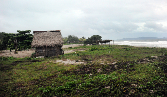 Garífuna huts on coast near Guaimoreto Lagoon.